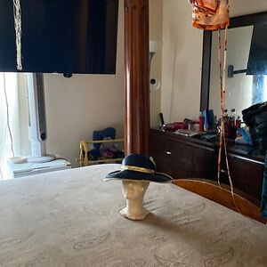 Navy blue hat trimmed in gold